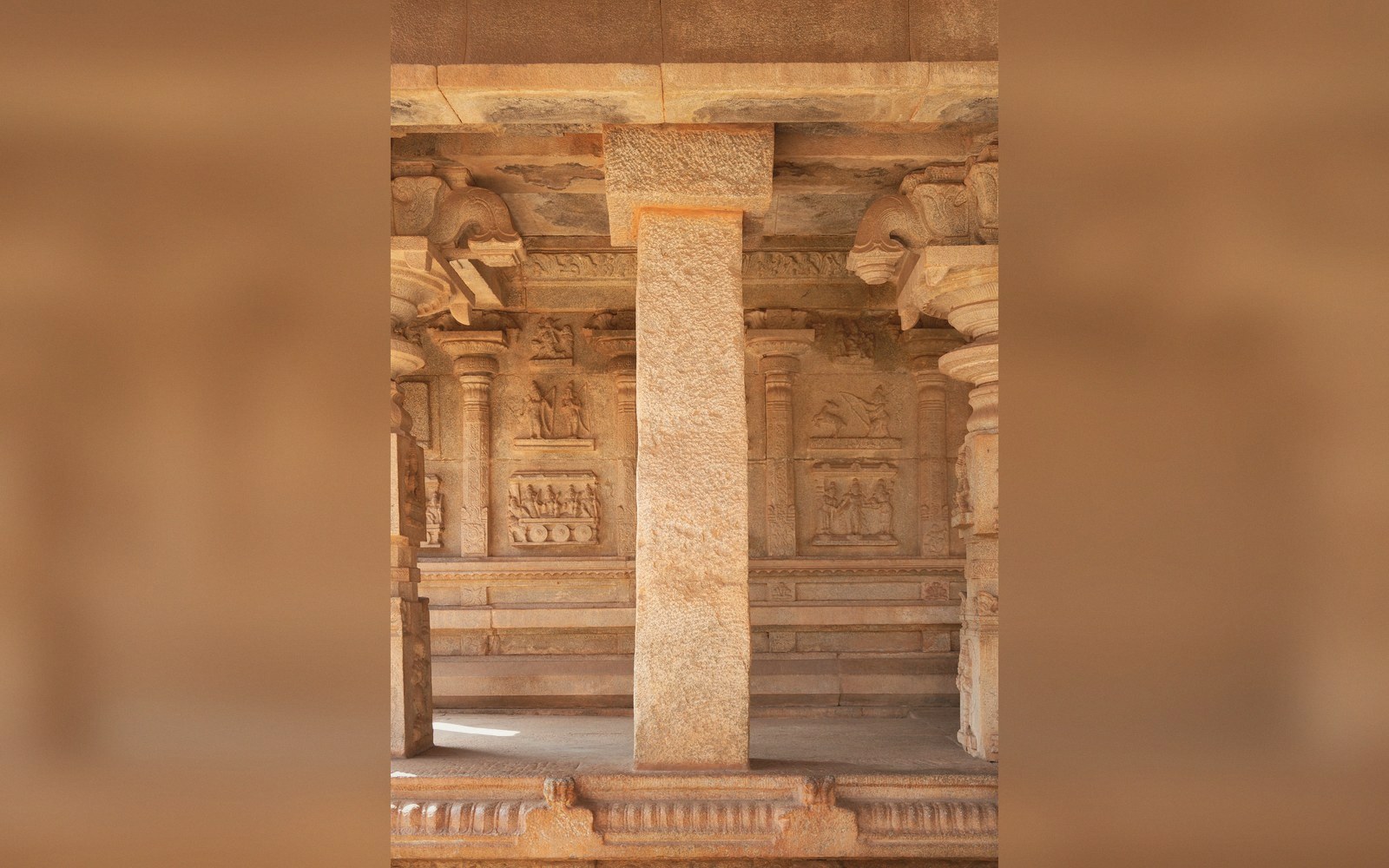 A monolithic carved column shaft, shadow deep in the cutting